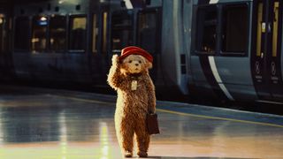 Paddington Bear walking through a train station