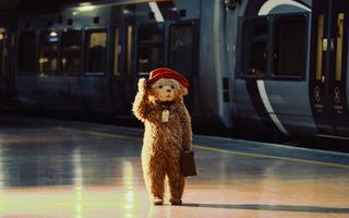 Paddington Bear walking through a train station