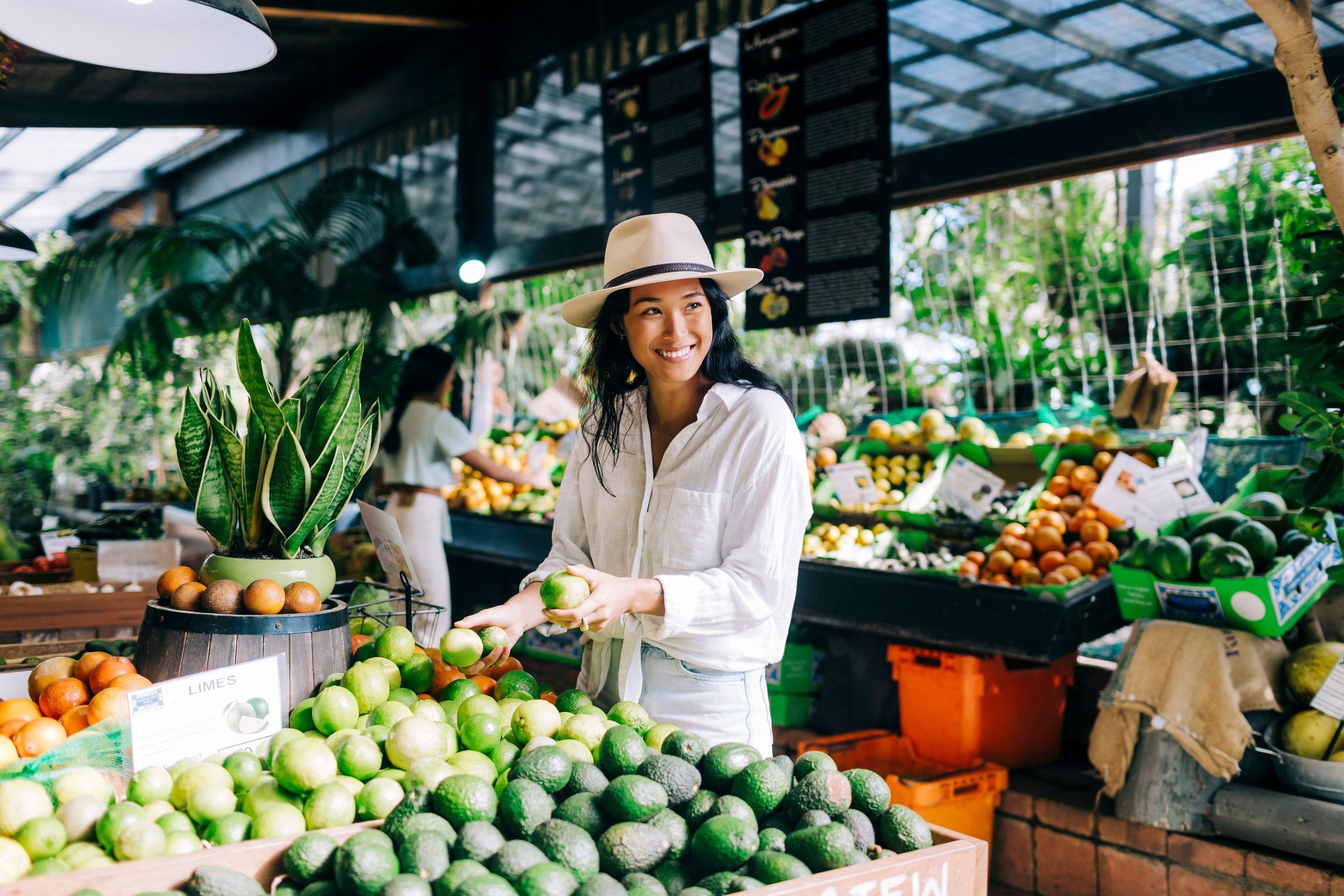 Woman purchasing fresh produce from Tropical Fruit World, Duranbah.