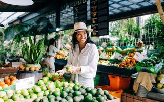 Woman purchasing fresh produce from Tropical Fruit World, Duranbah.