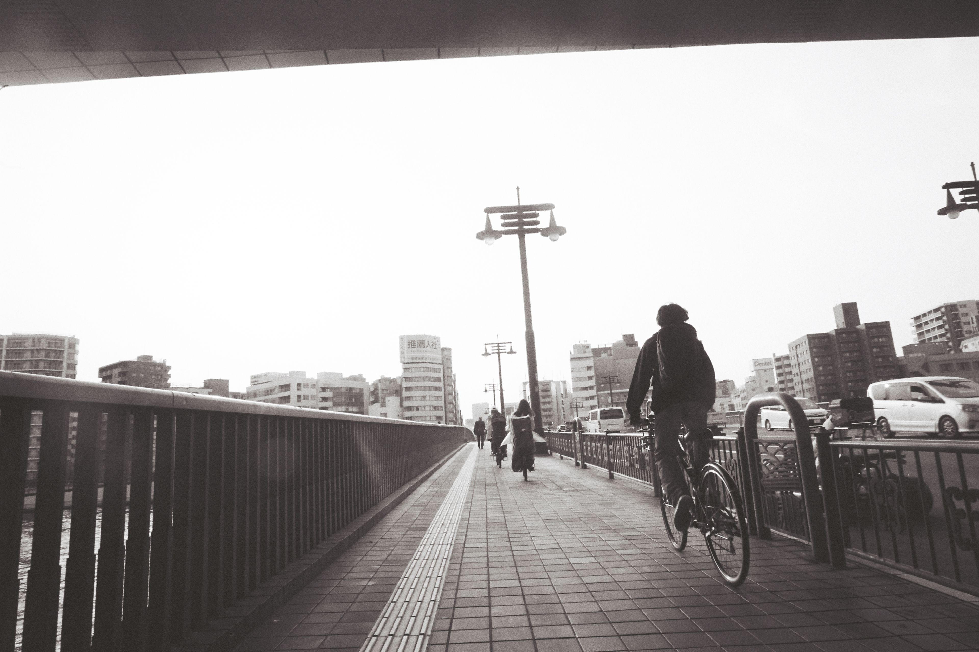 TOKYO CYCLISTS ON THE SUMIDA RIVER, 2025.