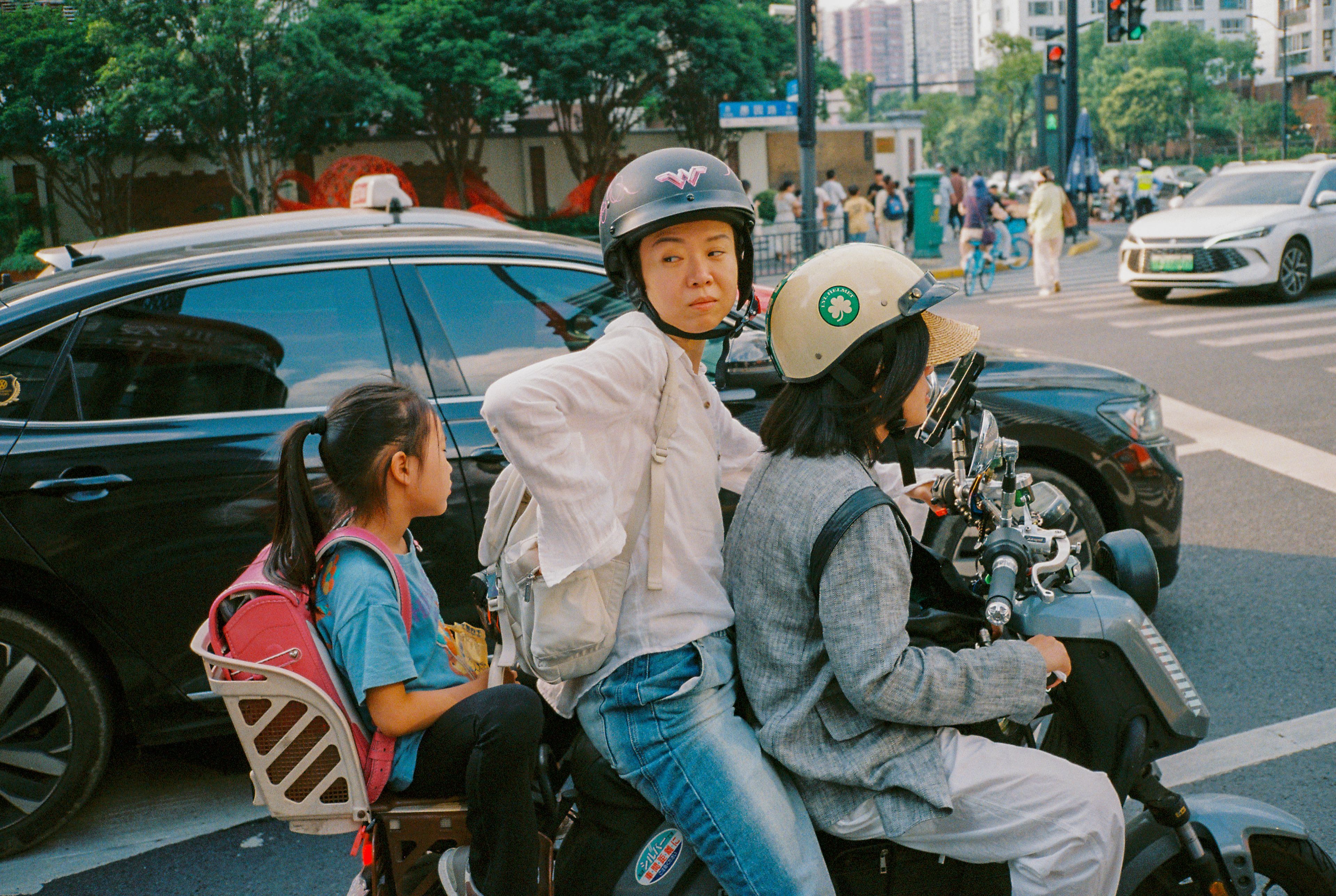 FAMILY ON A BIKE IN RUSH HOUR ON YUYUAN RD. SHANGHAI, 2025.