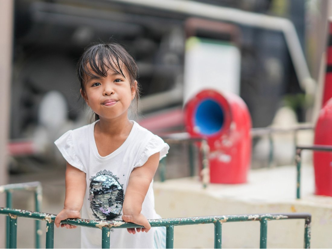 Yukiko standing against a green railing