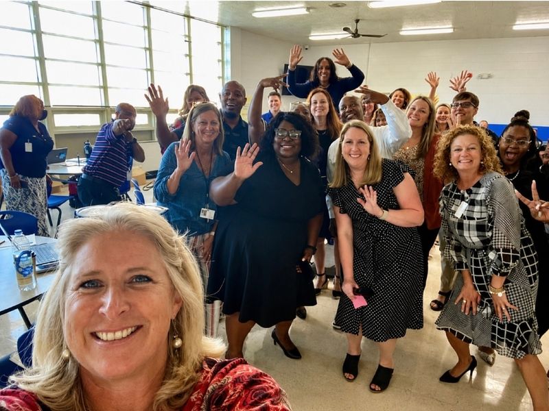 Dr. Takiwi with educators after a professional development session