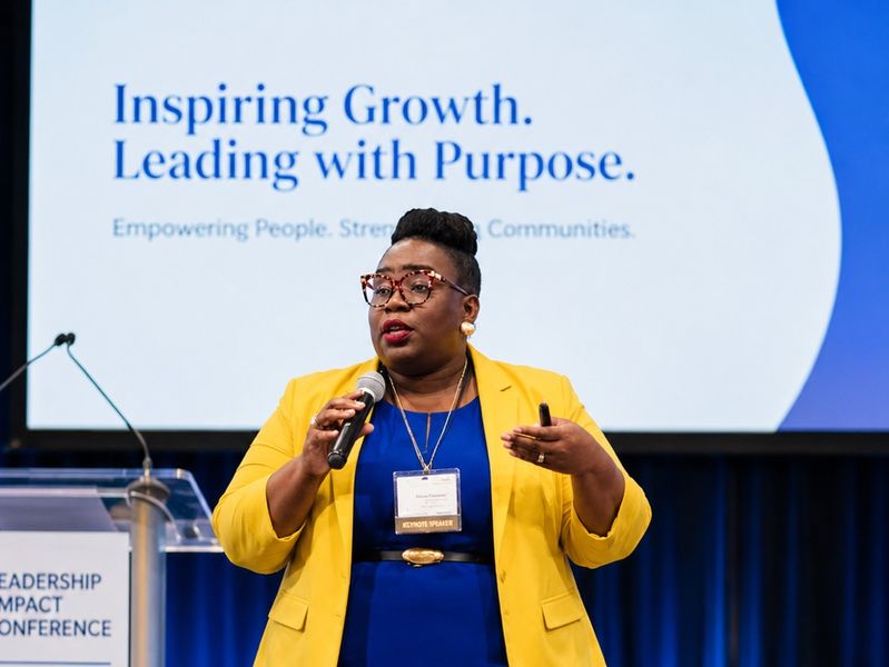 Dr. Takiwi delivering a keynote at a leadership conference