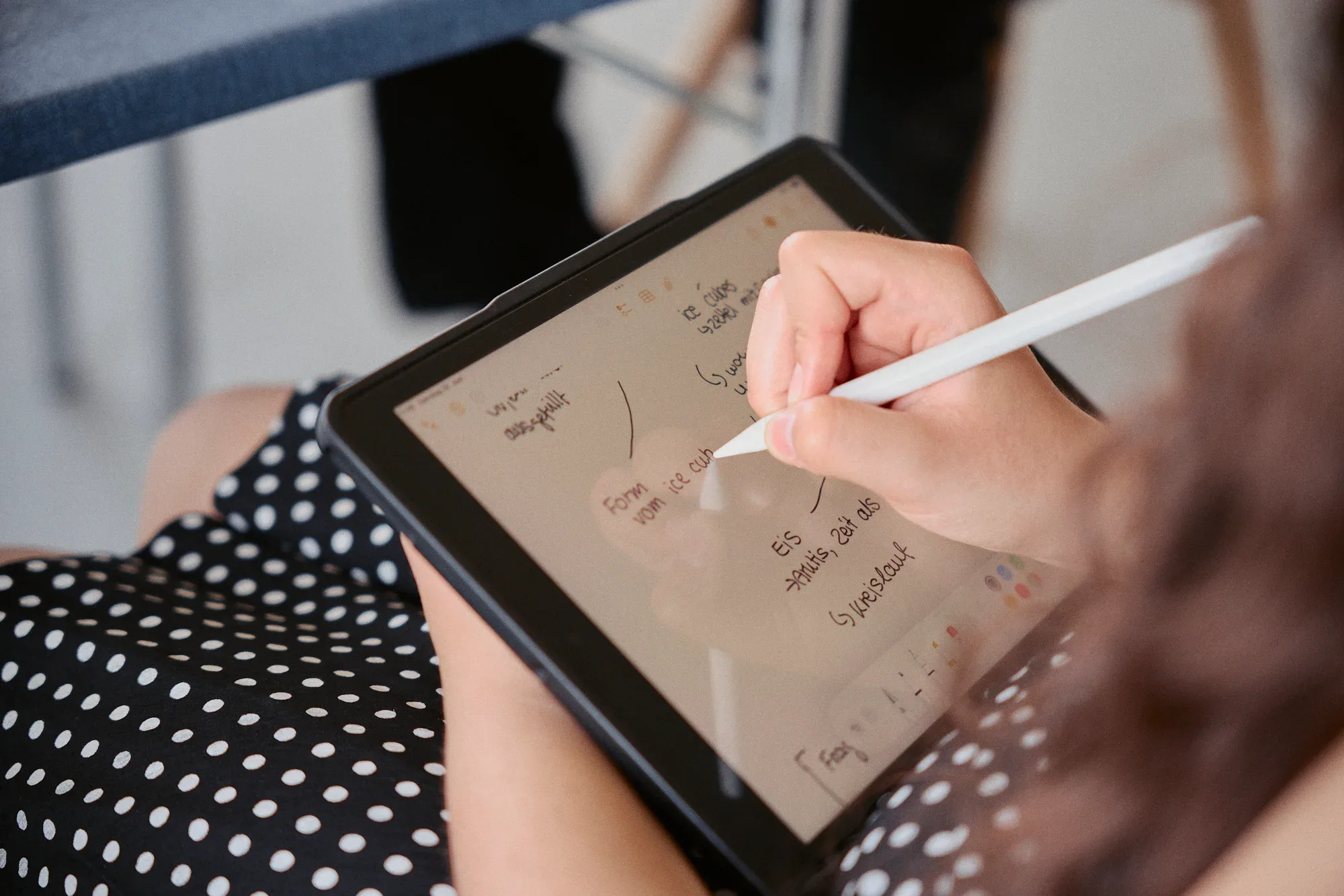 Sketching ideas on a tablet during a workshop.