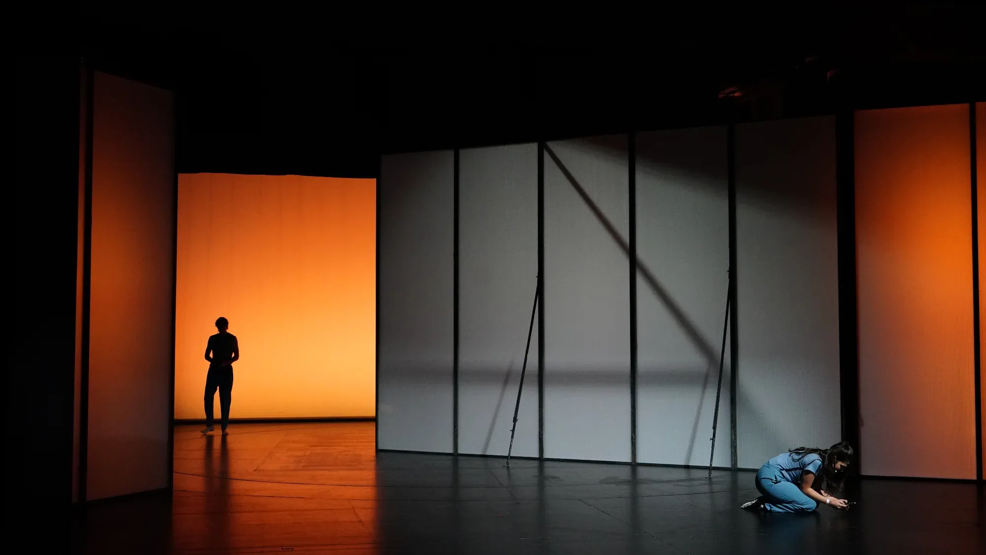 Orange light; a figure on the floor.