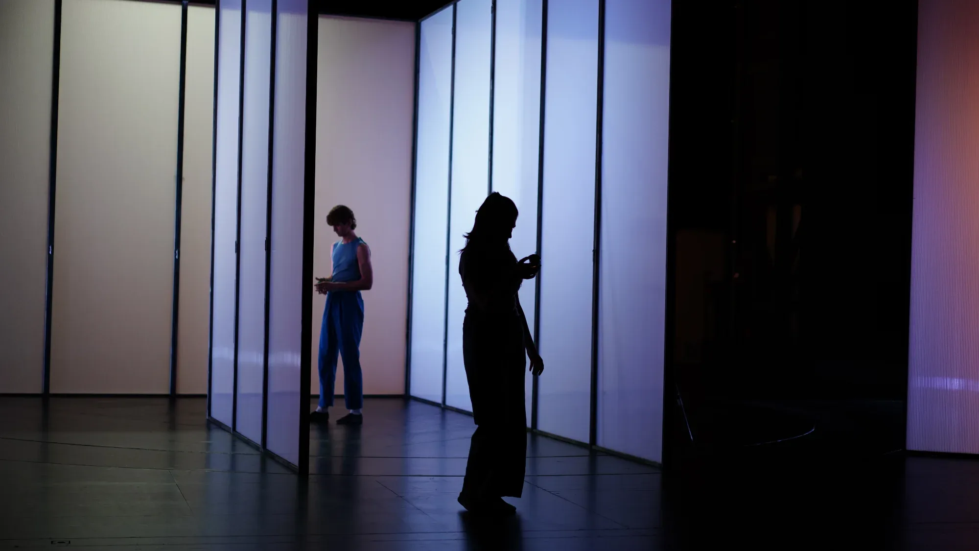 Two figures among the white walls of the trial.