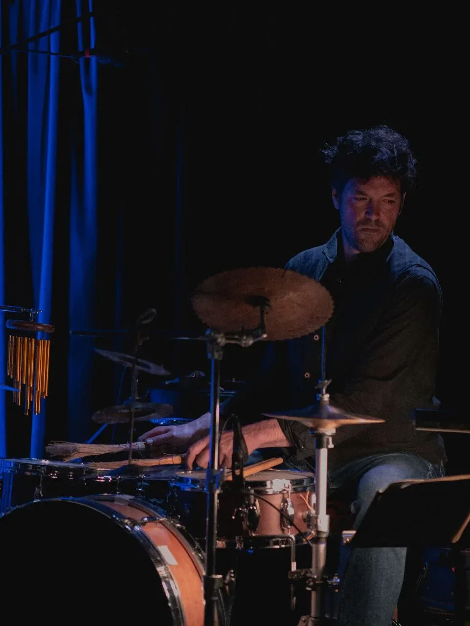 The musician at the drums.