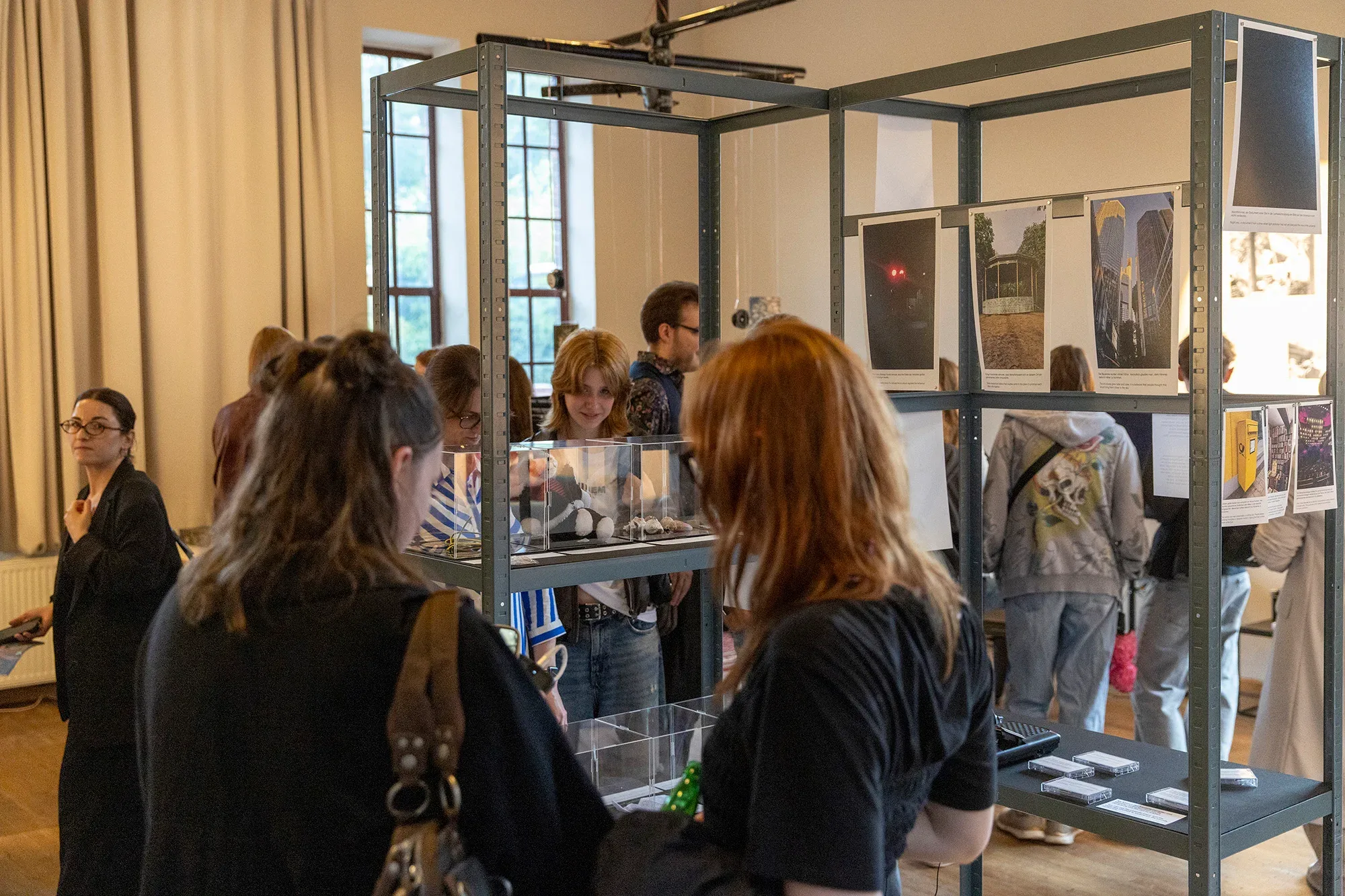 Visitors around a display case in the exhibition.