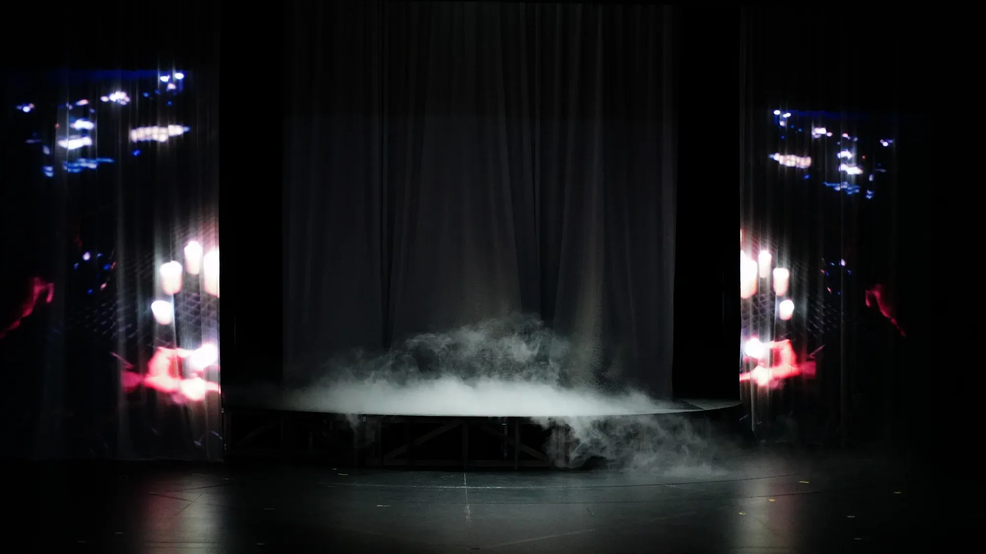 Smoke and light on an empty stage.