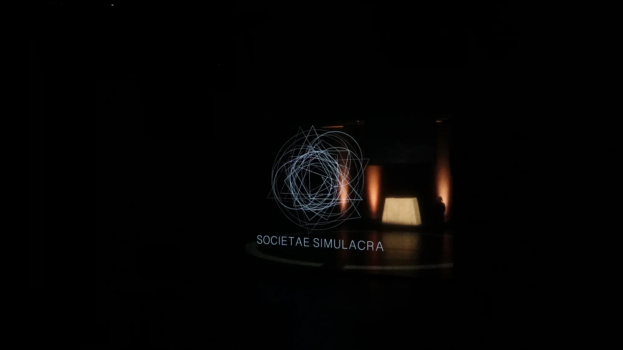 The title, projected into the dark.