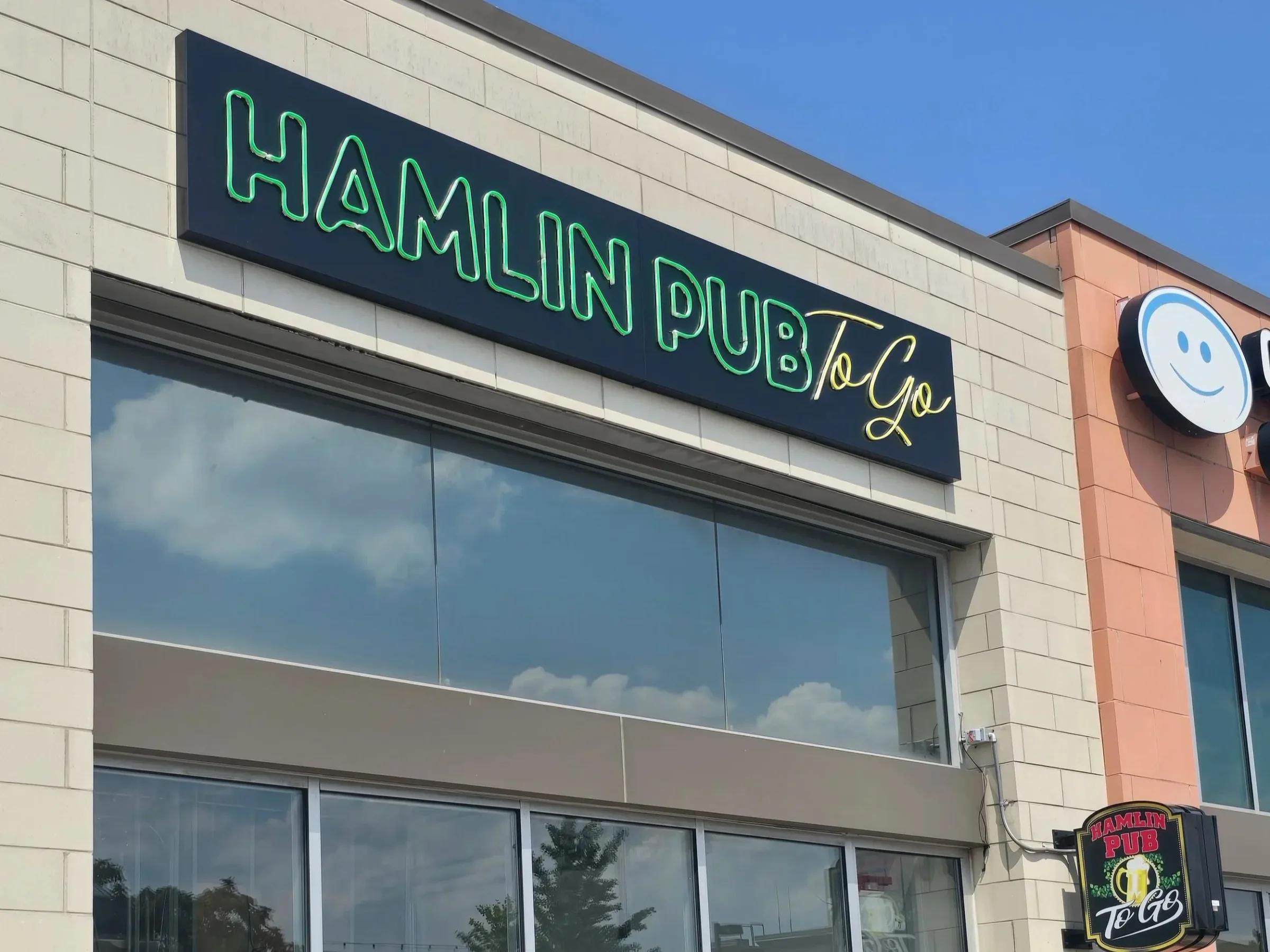Hamlin Pub To Go channel letters on a storefront fascia by day