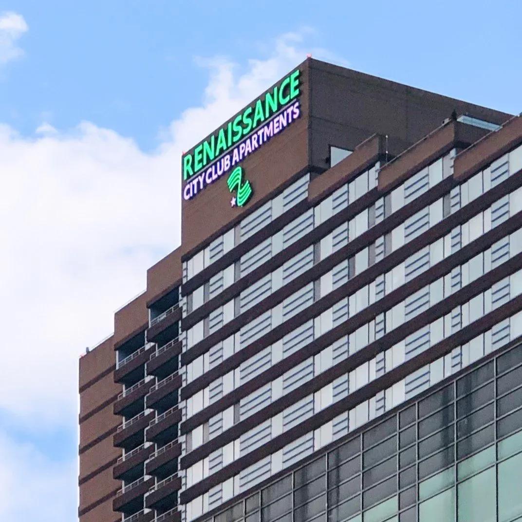 Green Renaissance City Club Apartments letters at the top of a high-rise building