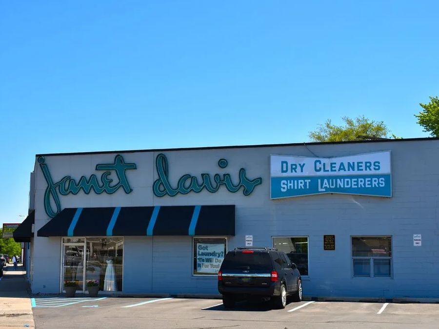 Janet Davis script letters and a Dry Cleaners panel on a white building