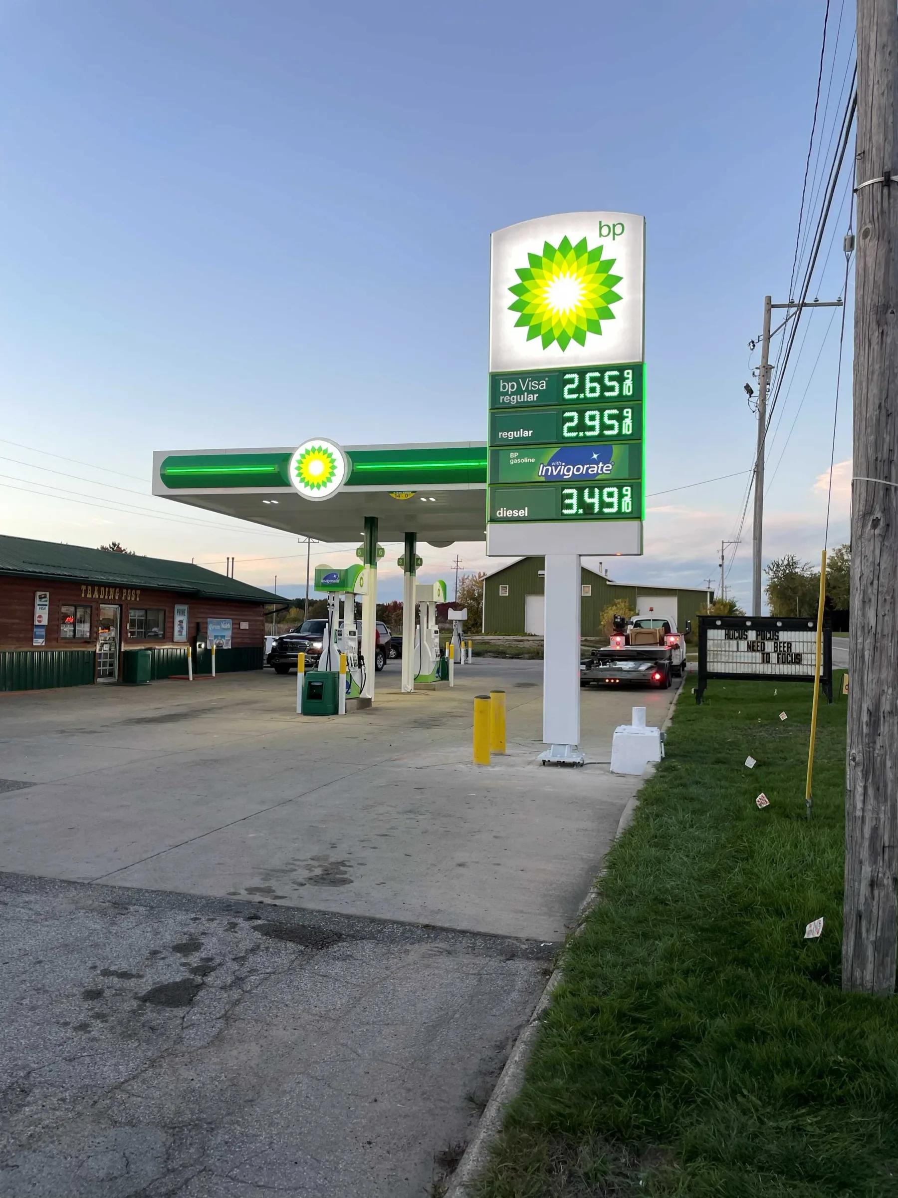 BP station with a green canopy and a tall BP price sign showing LED fuel prices