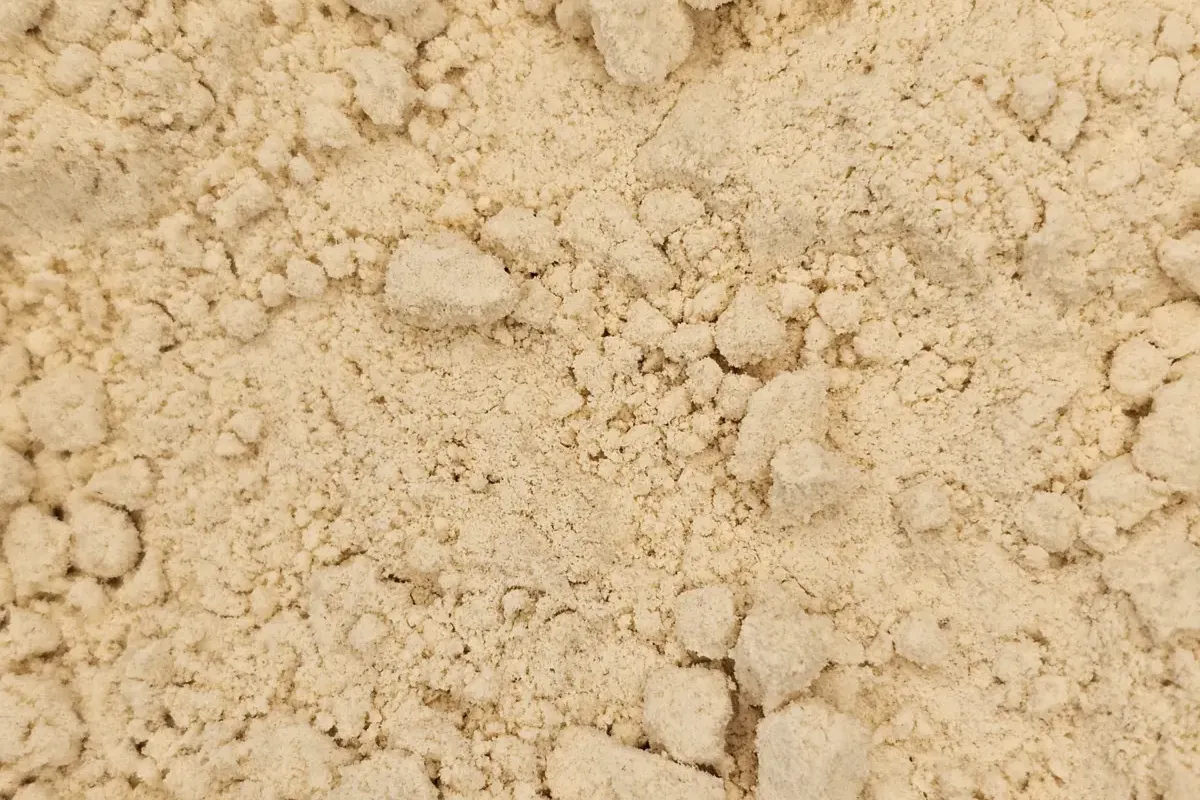 Close-up of rich, yellow Full Fat Yellow Mustard Flour, highlighting its fine, smooth powder texture.