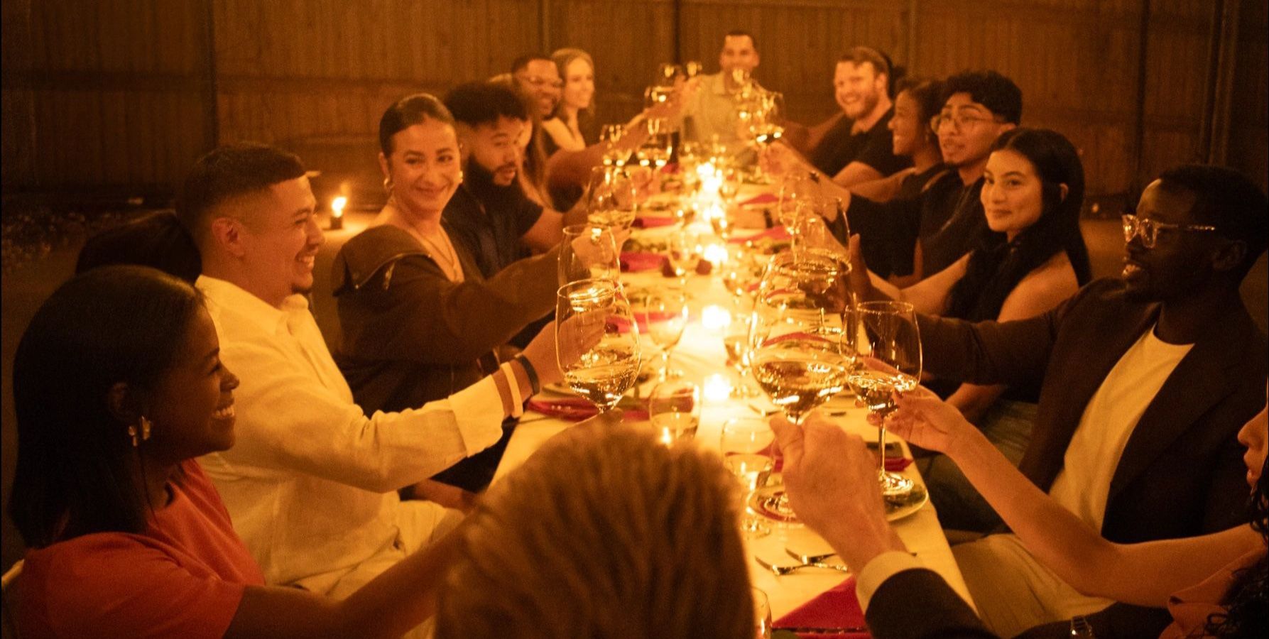 XVI guests enjoying dinner and conversation at the long table