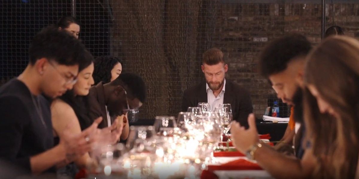 XVI guests bowing in prayer at the dinner table
