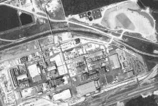 A gray-scale aerial photograph of a factory