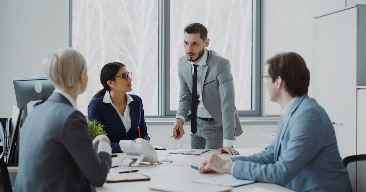 Business professionals discussing shareholder agreements in boardroom