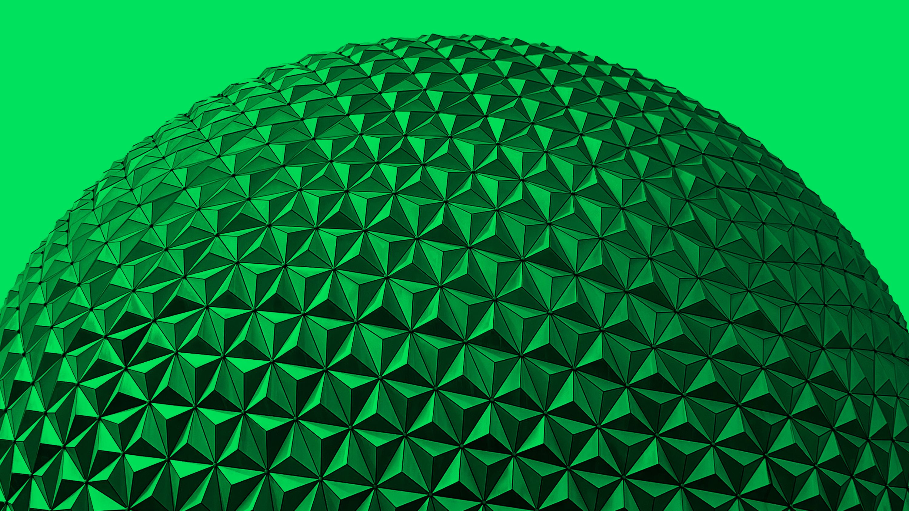A close-up of EPCOT's Spaceship Earth geodesic sphere, tinted green