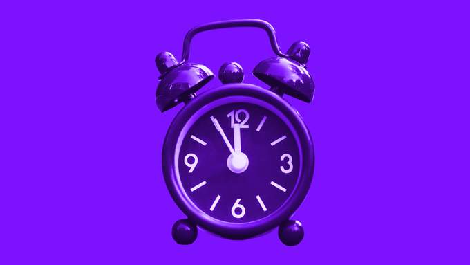 A vintage alarm clock tinted purple, its hands near twelve