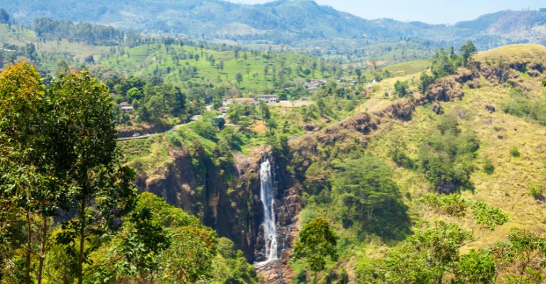 A waterfall cutting through the tea-covered hills near Nuwara Eliya