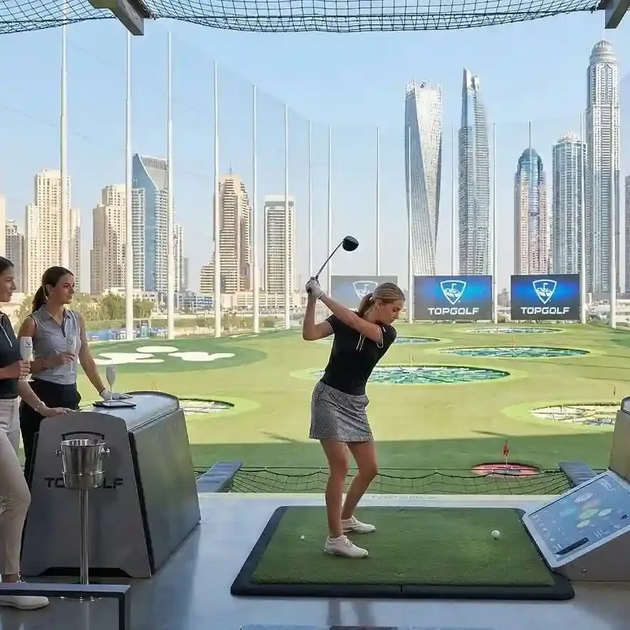 Golf course in Dubai with lush green fairways and modern skyline backdrop