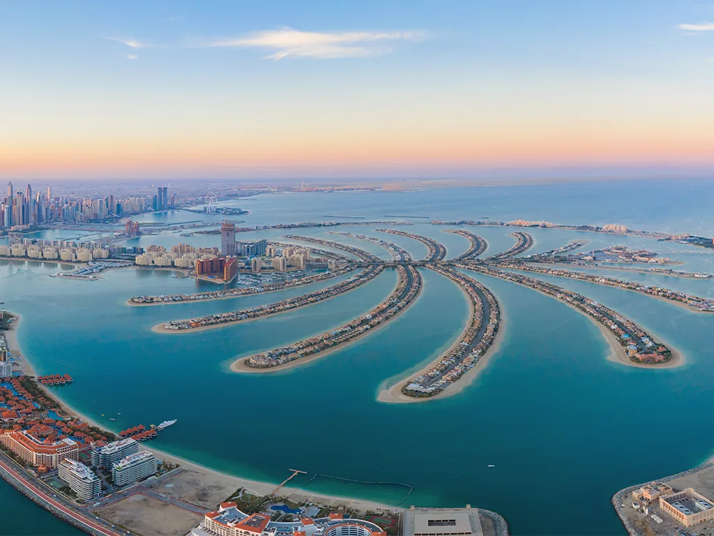 Aerial view of Palm Jumeirah and the Dubai skyline at sunset