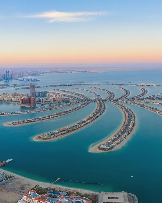 Aerial view of Palm Jumeirah and the Dubai skyline at sunset