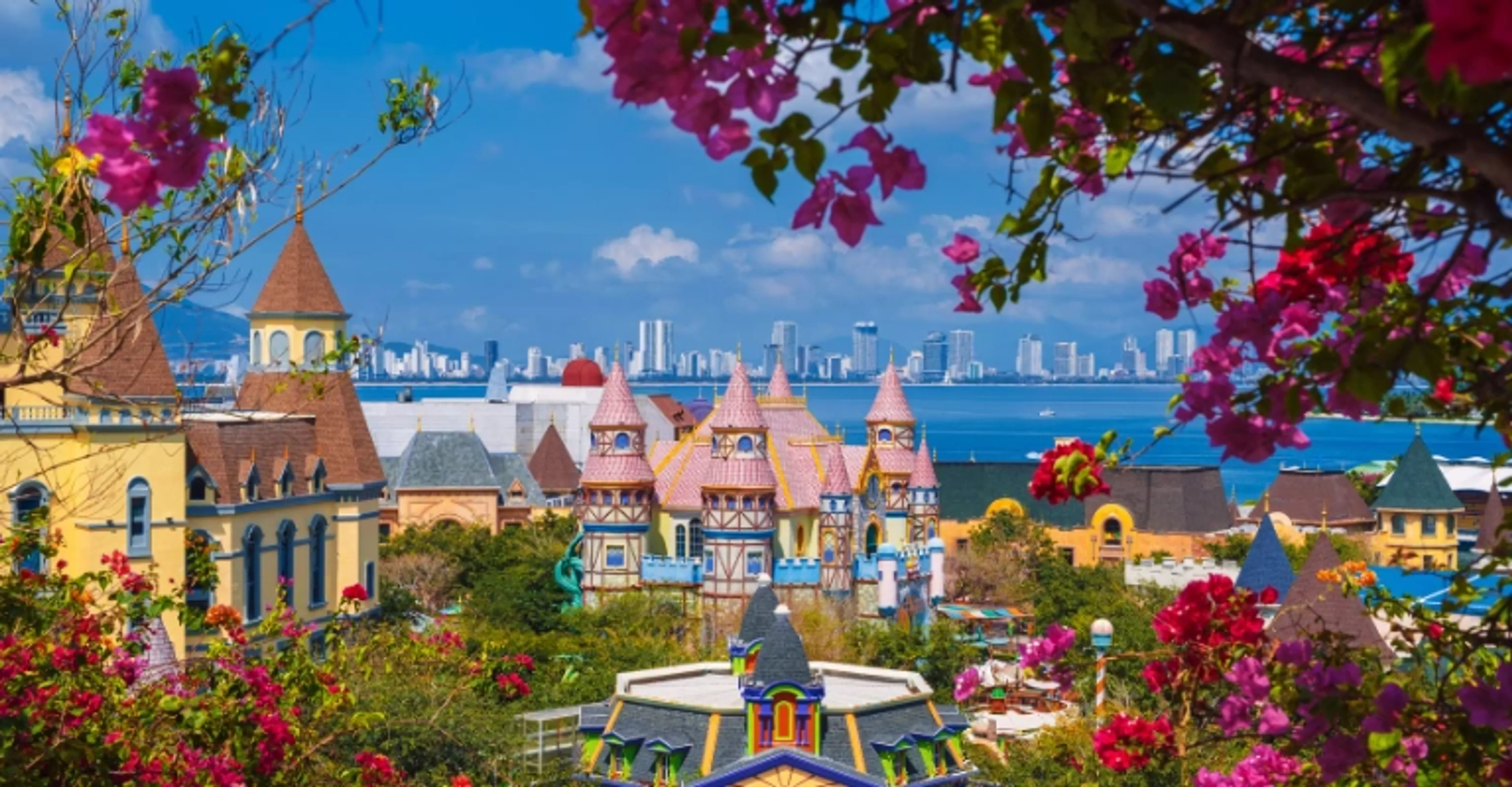 Fairytale-style towers of VinWonders Phu Quoc framed by bougainvillea