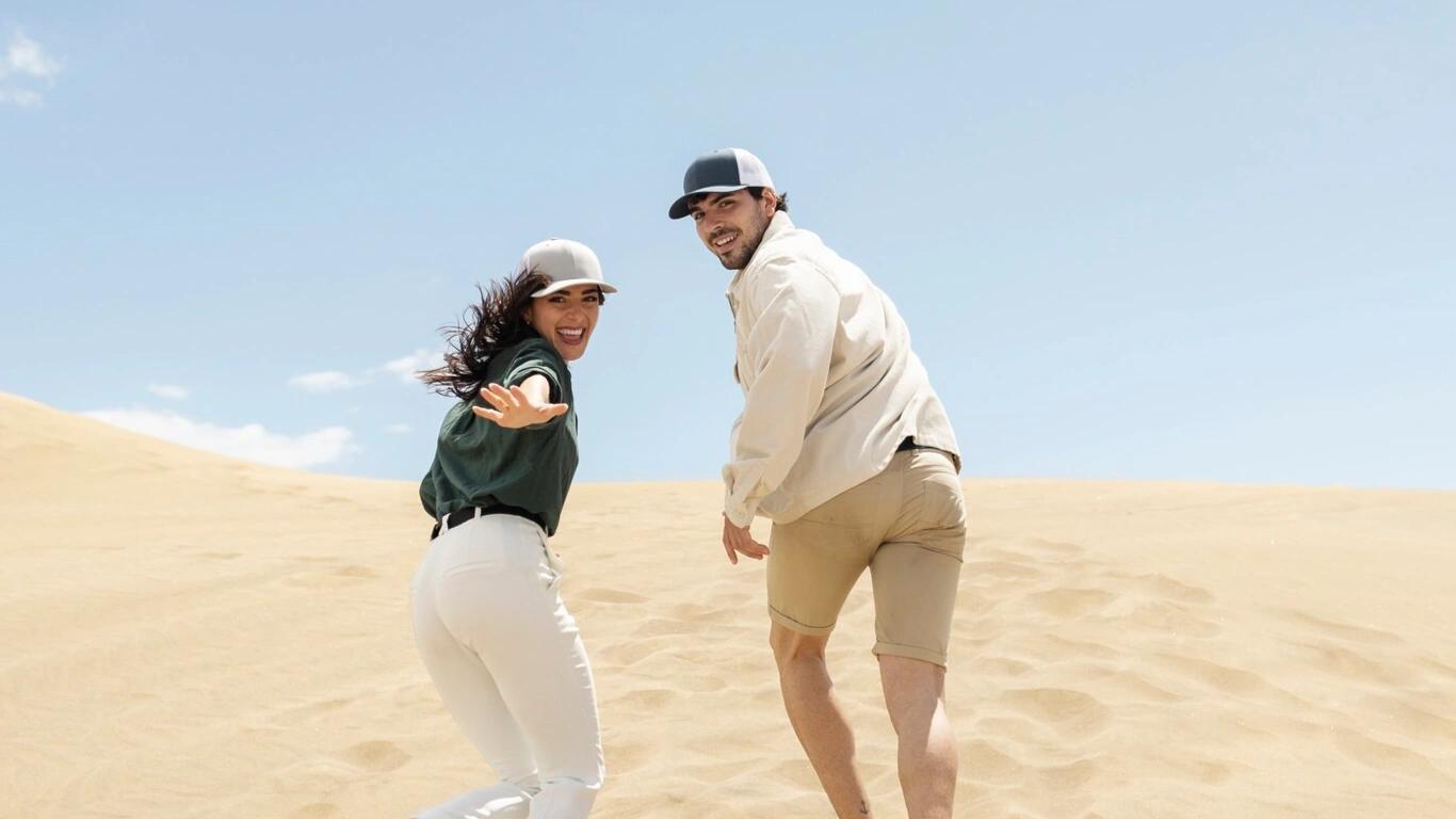 Couple enjoying a playful moment on the Dubai desert dunes