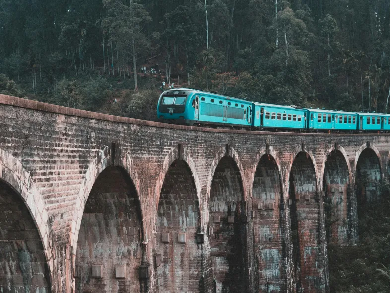 The blue hill-country train crossing the Nine Arches Bridge near Ella, Sri Lanka