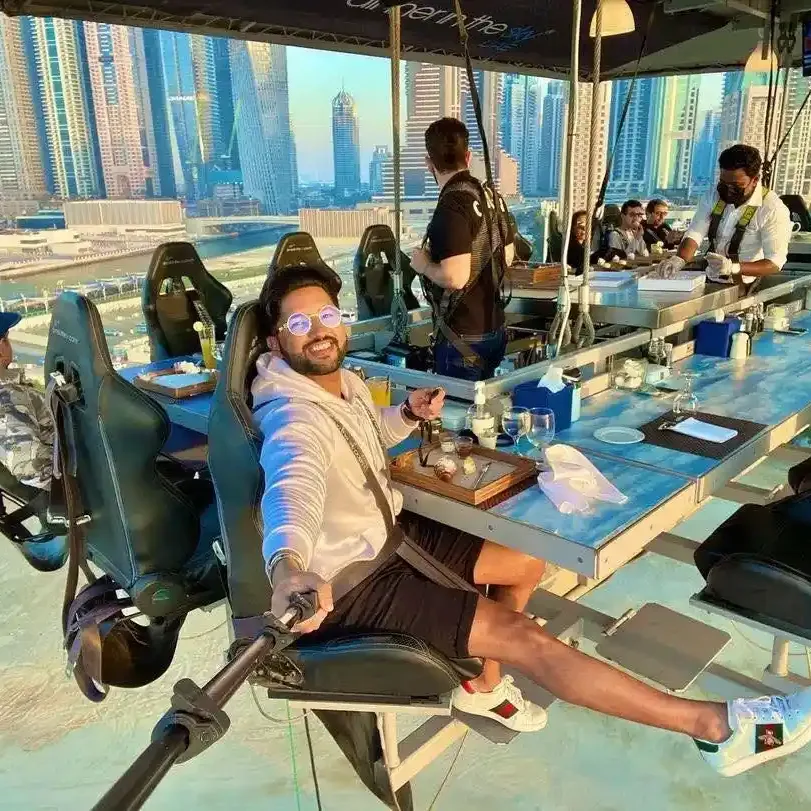 Guests dining on Dinner in the Sky experience overlooking Dubai skyline