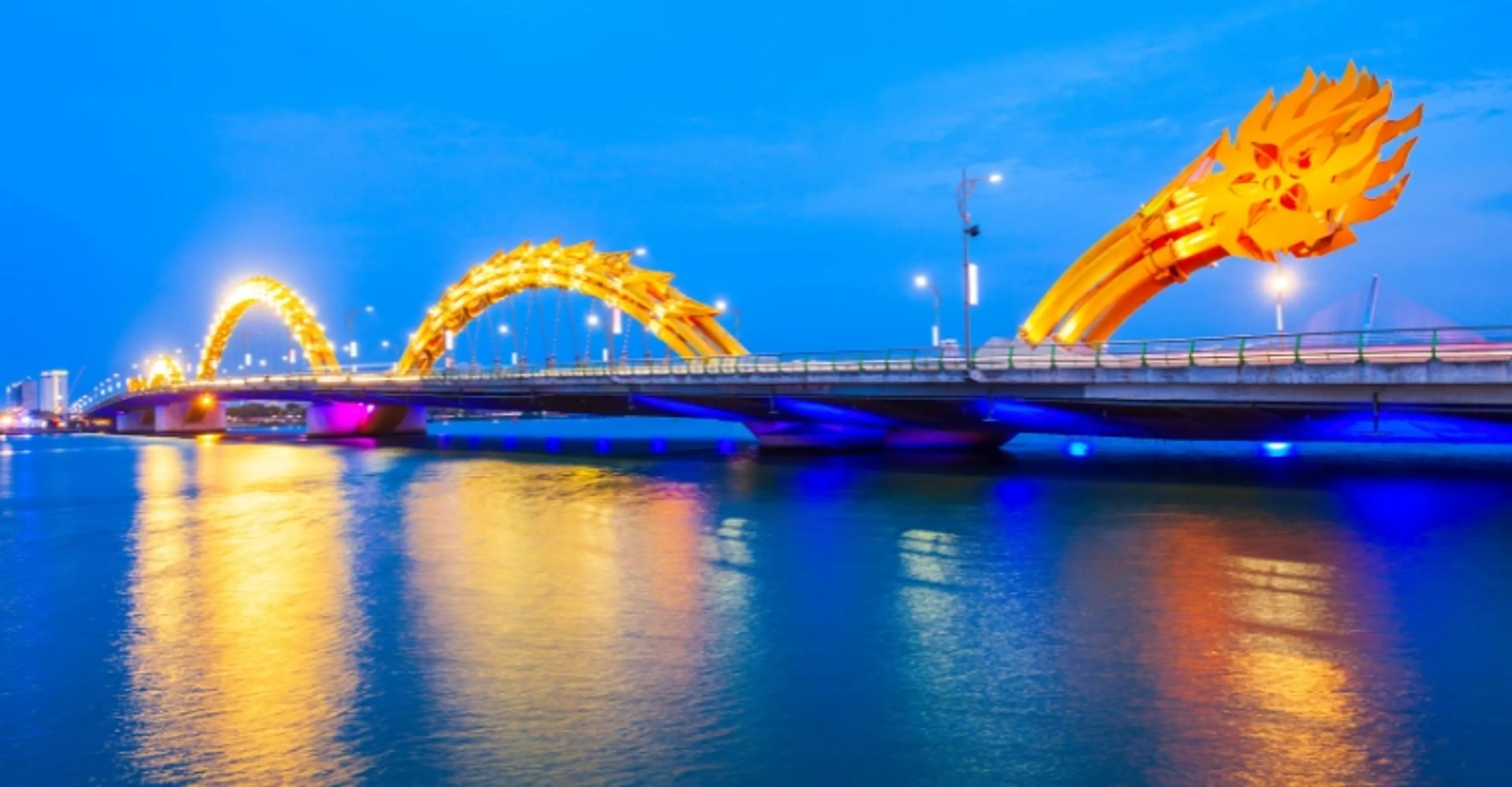 Dragon Bridge in Danang illuminated gold at night