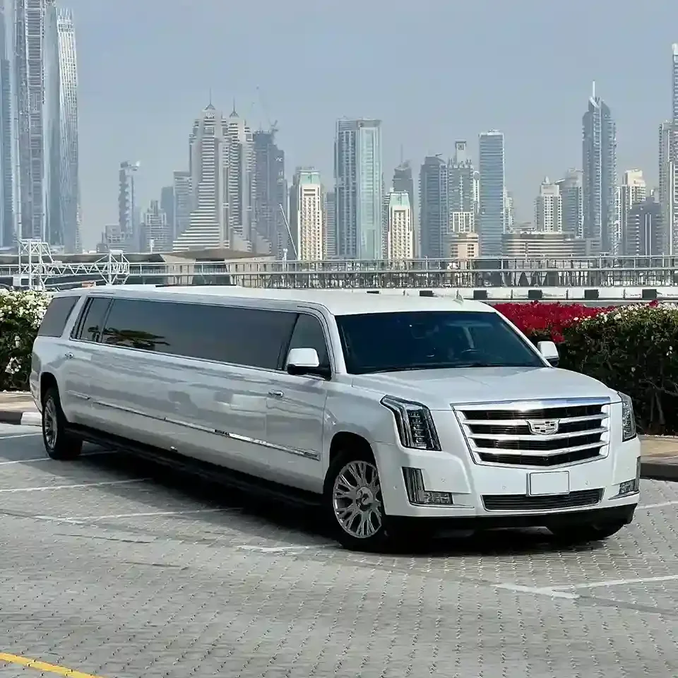 Luxury limousine driving through Dubai city with iconic landmarks in view