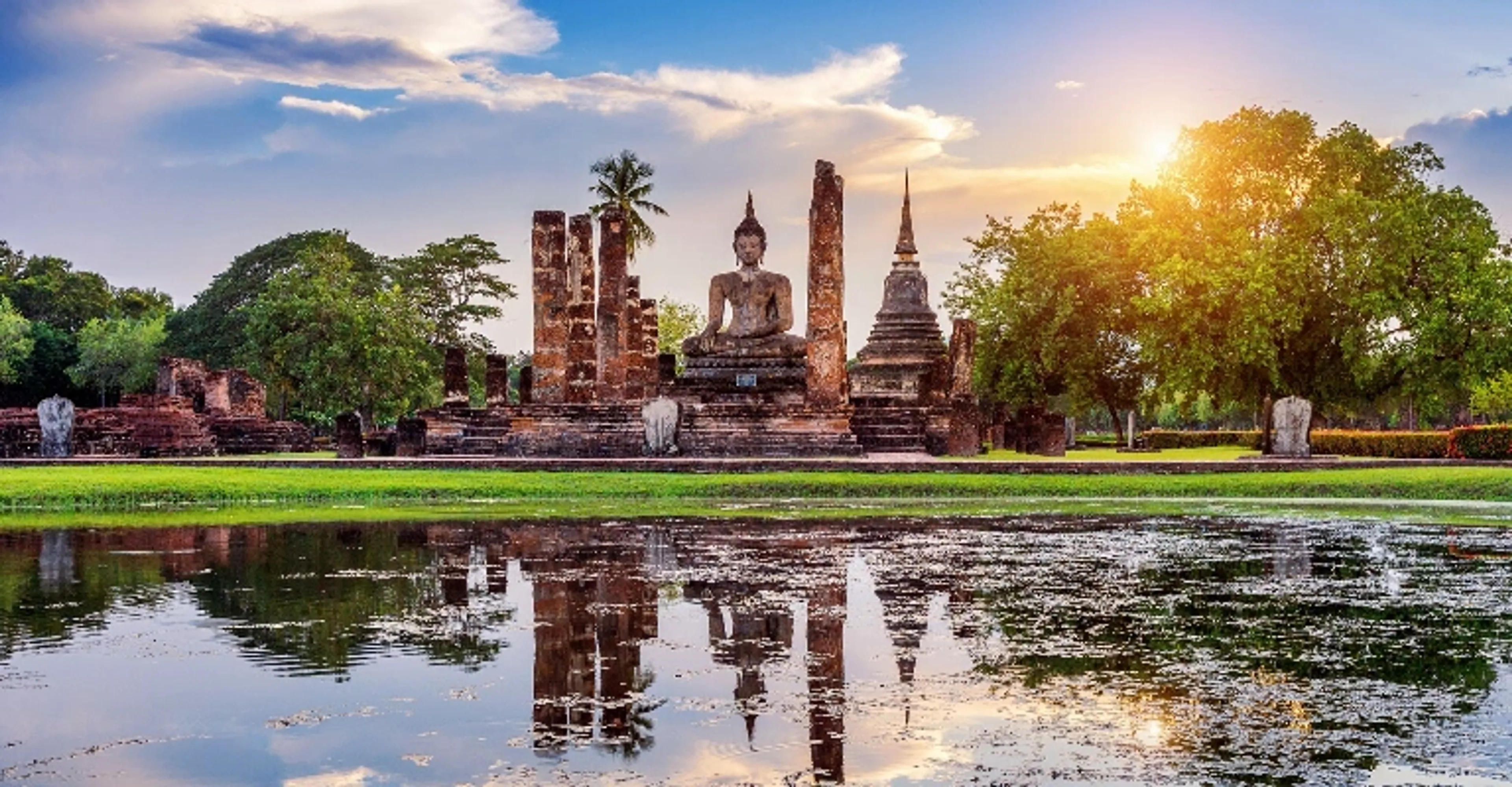 Golden temple against a Thailand skyline at dusk