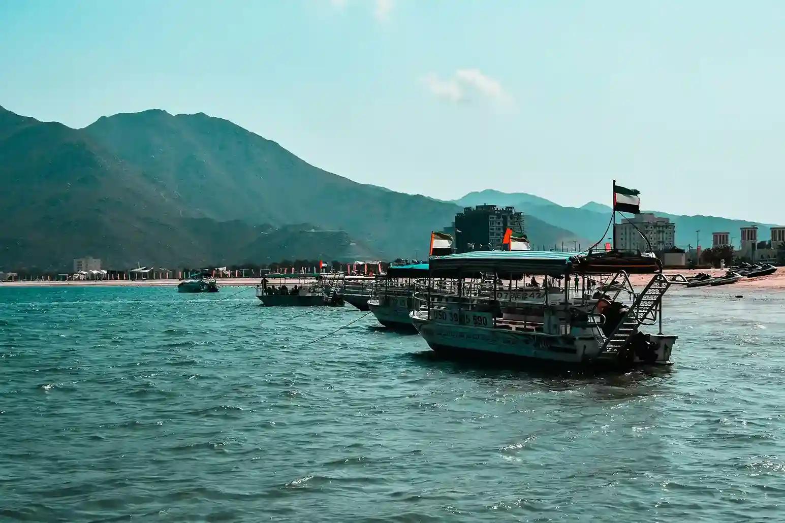 Khor Fakkan beach with mountains, clear water, and scenic coastal views