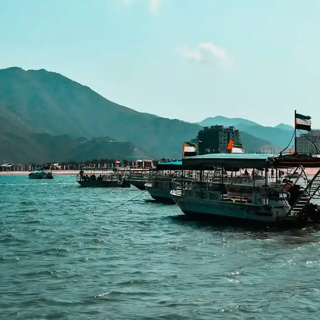 Khor Fakkan beach with mountains, clear water, and scenic coastal views