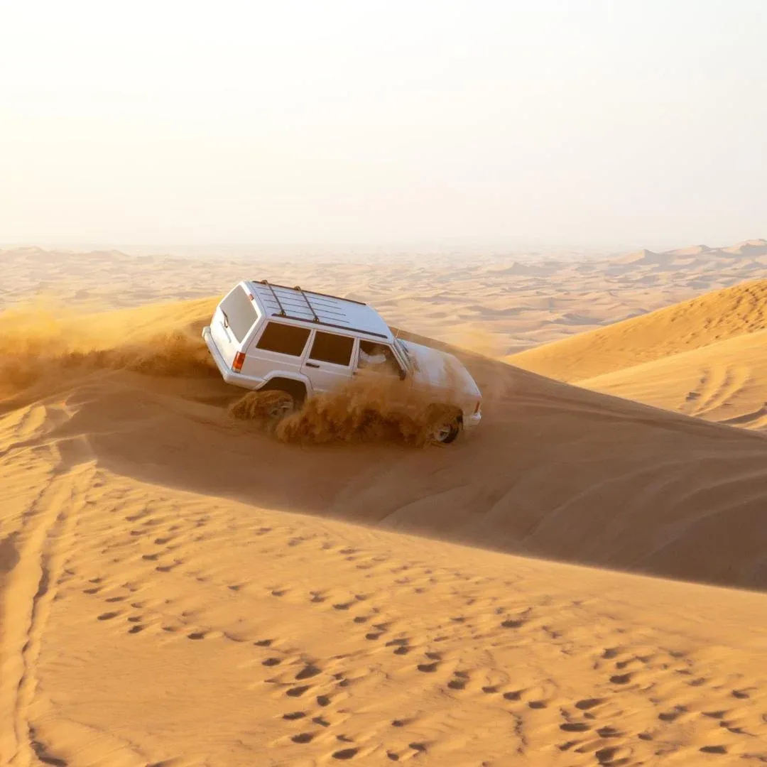 Desert safari adventure with dune bashing and camel rides in Ajman desert