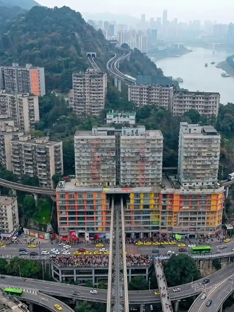 Liziba Station Chongqing with train passing through a residential building and urban surroundings