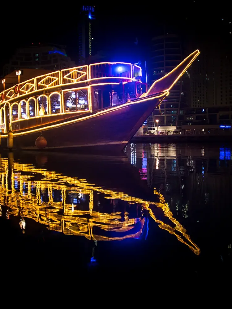 Luxury dinner cruise yacht sailing in Dubai Marina at night