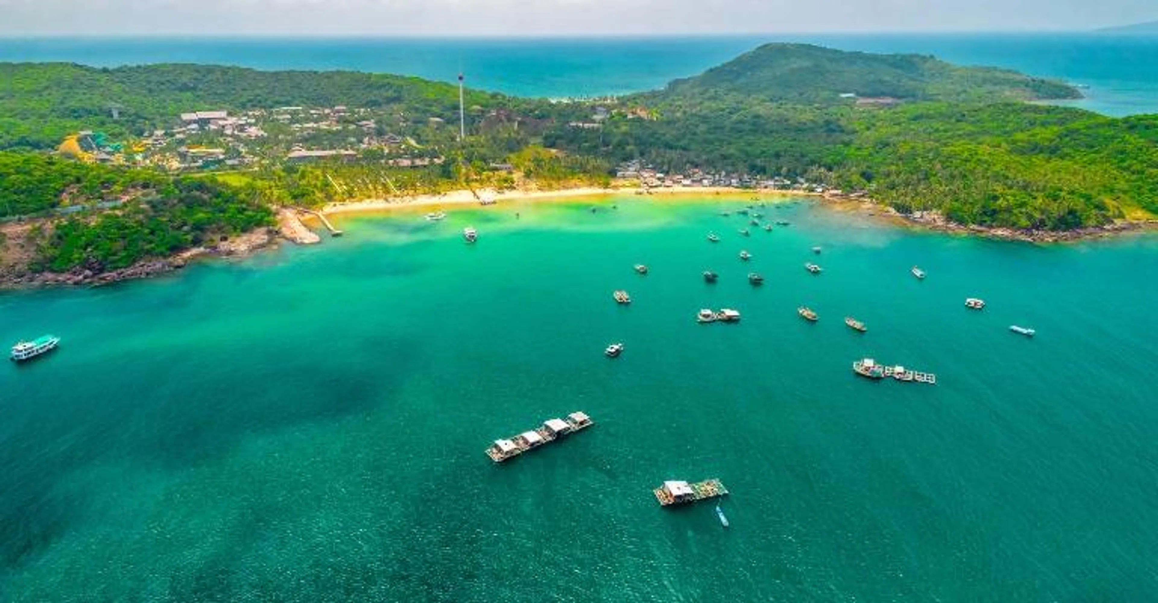 Aerial view of boats anchored in the turquoise waters off a Phu Quoc beach