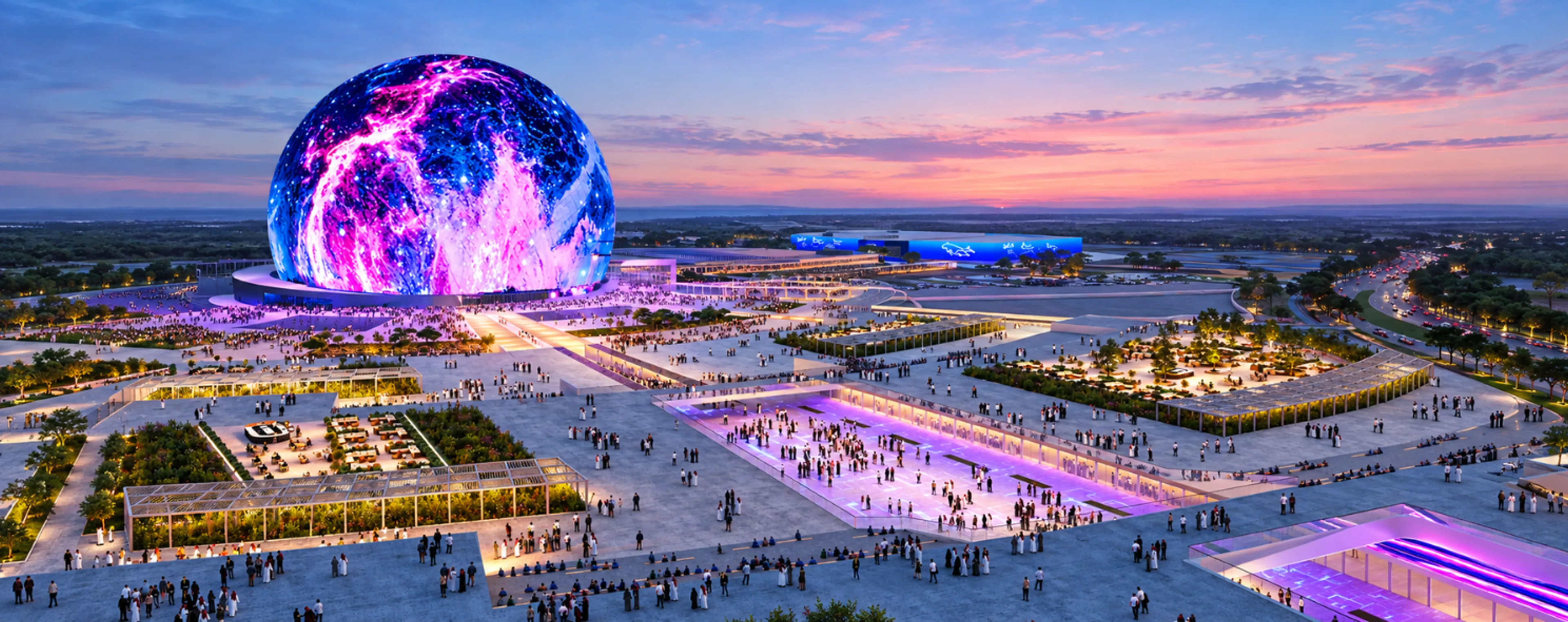 Illuminated sphere entertainment venue surrounded by crowds and plazas at dusk