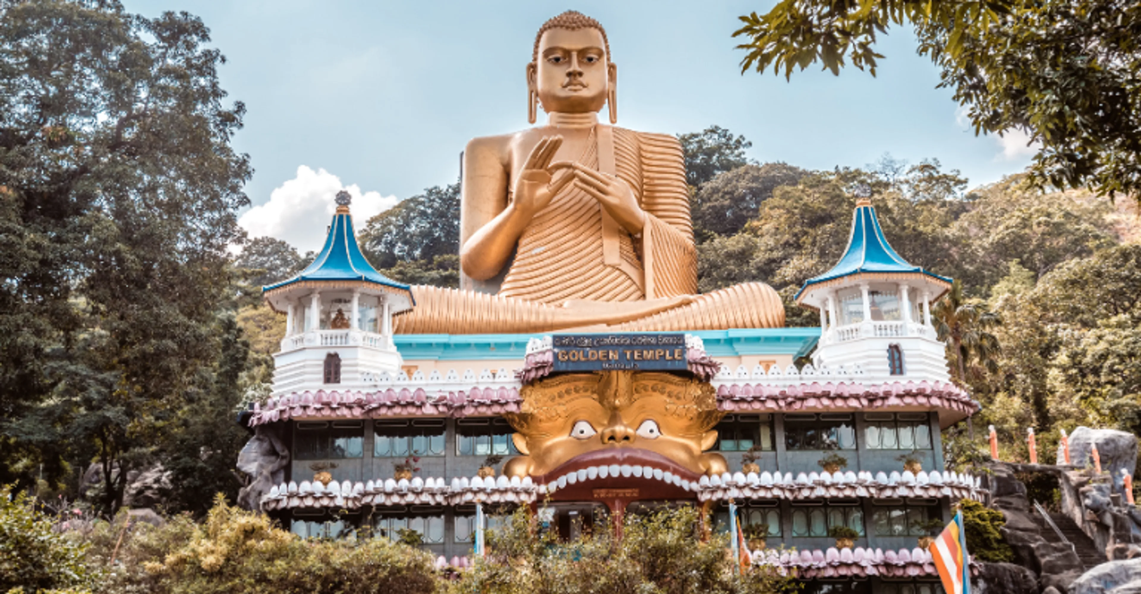 Golden Buddha statue atop the Golden Temple of Dambulla, Sri Lanka.