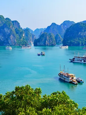 Halong Bay cruise with limestone islands and emerald waters in Vietnam