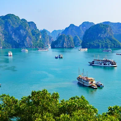 Halong Bay cruise with limestone islands and emerald waters in Vietnam