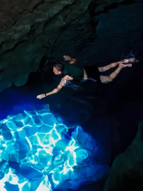 Visitor ziplining across the river before cave swimming at Dark Cave Vietnam