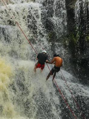 Adventurer abseiling down a waterfall during a canyoning trip in Đà Lạt Vietnam